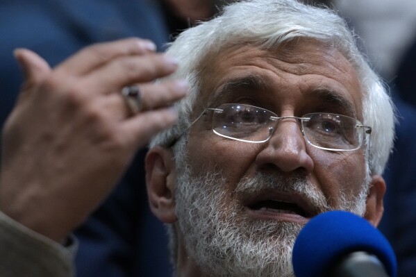 Iranian presidential candidate Saeed Jalili, a hard-line former nuclear negotiator, speaks to a group of athlete supporters during a campaign stop at a sports hall in Tehran, Iran, Sunday, June 30, 2024. (AP Photo/Vahid Salemi)