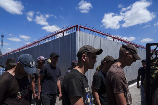 Prisoners go for lunch in a prison, in the Dnipropetrovsk region, Ukraine, Friday, June 21, 2024. Ukraine is expanding its military recruiting to cope with battlefield shortages more than two years into fighting Russia’s full-scale invasion. (AP Photo/Evgeniy Maloletka)
