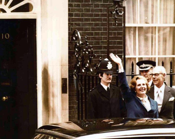 FILE - Britain's Conservative Party leader Margaret Thatcher waves to wellwishers as she arrives at 10 Downing Street, London with her husband Denis at right, May 4, 1979. Britain’s upcoming general election on July 4, 2024, is widely expected to lead to a change of government for the first time in 14 years. Britain's general election in 1979 is without doubt the most consequential since 1945, with Margaret Thatcher becoming the country’s first female prime minister on a radical Conservative economic agenda. At its heart, Thatcherism represented a total rethink over the role of the state. (AP Photo/Bob Dear, File)