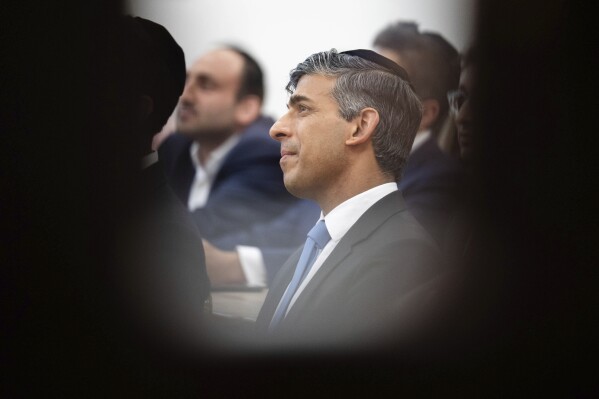 Britain's Prime Minister Rishi Sunak looks on during a visit to Machzike Hadath Synagogue, in Golders Green, while on the general election campaign trail, in north west London, Sunday June 30, 2024. (James Manning/Pool Photo via AP)