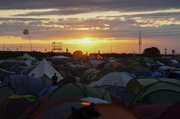 Sunset on day two of the Glastonbury Festival in Worthy Farm, Somerset, England, Saturday, June 29, 2024. (Scott A Garfitt/Invision/AP)