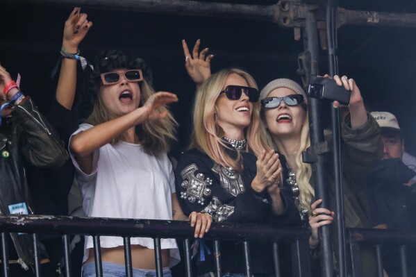 Cara Delevingne, from left, Lady Mary Charteris and Anya Taylor-Joy attend the Avril Lavigne performance during the Glastonbury Festival in Worthy Farm, Somerset, England, Sunday, June 30, 2024. (Joel C Ryan/Invision/AP)
