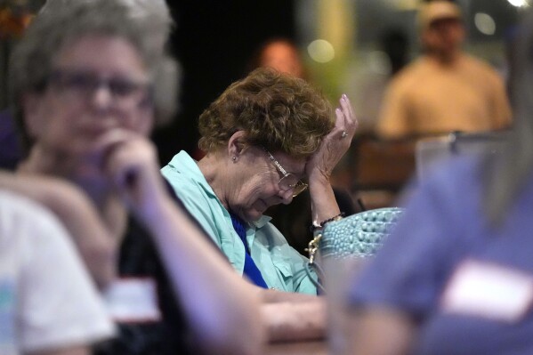 Deb Moore of Saco, Maine, reacts to a comment by Republican presidential candidate former President Donald Trump during the presidential debate with President Joe Biden, during a watch party at Broadway Bowl, Thursday, June 27, 2024, in South Portland, Maine. (AP Photo/Robert F. Bukaty)