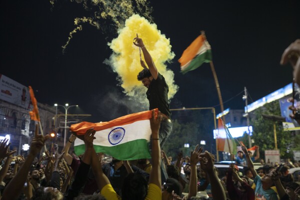 Cricket fans celebrate in Lucknow, capital of northern Indian state of Uttar Pradesh, India, Sunday, June 30, 2024, after India defeated South Africa in the ICC T20 World Cup final match in Barbados. (AP Photo/Rajesh Kumar Singh)