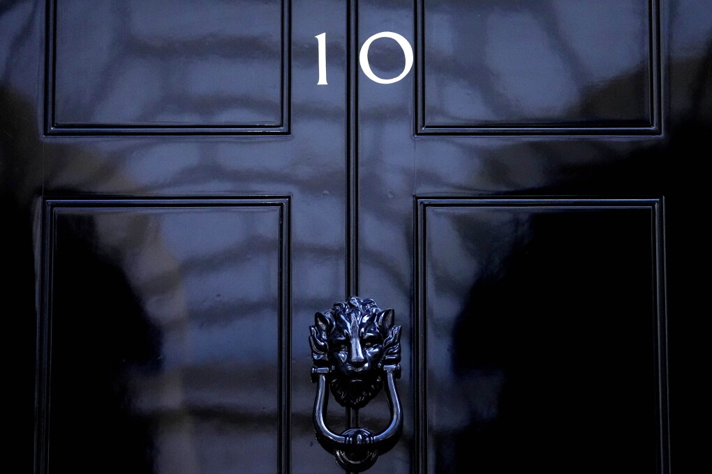 FILE - The door to 10 Downing Street in London, Friday, July 8, 2022. The United Kingdom will hold its first national election in almost five years on Thursday, with opinion polls suggesting that Prime Minister Rishi Sunak’s Conservative Party will be punished for failing to deliver on promises made during 14 years in power. (AP Photo/Frank Augstein, File)