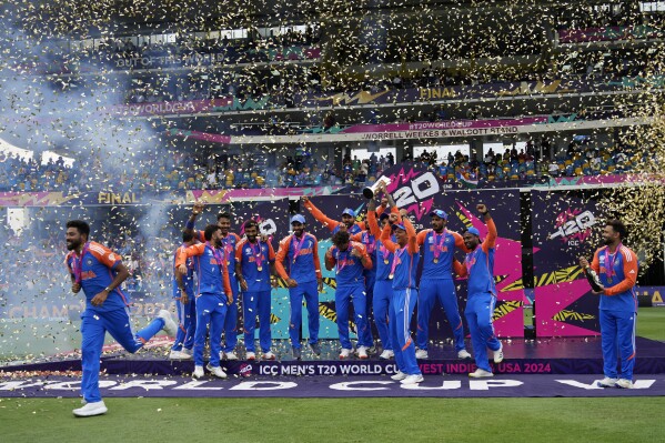 India's players celebrate with the trophy after winning the ICC Men's T20 World Cup final cricket match against South Africa at Kensington Oval in Bridgetown, Barbados, Saturday, June 29, 2024. (AP Photo/Ramon Espinosa)