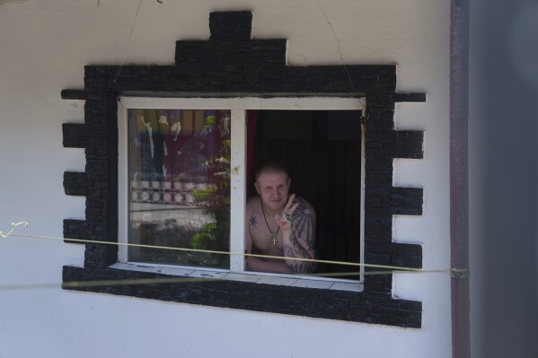 A prisoner looks though the window of his barrack in a prison, in the Dnipropetrovsk region, Ukraine, Friday, June 21, 2024. Ukraine is expanding its military recruiting to cope with battlefield shortages more than two years into fighting Russia’s full-scale invasion. (AP Photo/Evgeniy Maloletka)