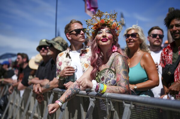 A festival-goer is pictured before the Cyndi Lauper performance during the Glastonbury Festival in Worthy Farm, Somerset, England, Saturday, June 29, 2024. (Scott A Garfitt/Invision/AP)