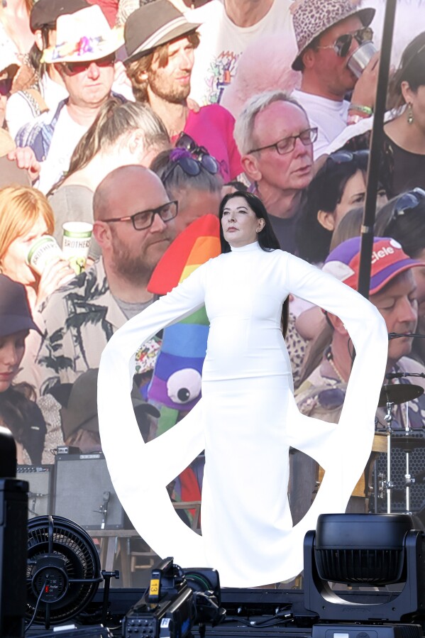 Marina Abramovic invites festival-goers to join a seven-minute silence during the Glastonbury Festival in Worthy Farm, Somerset, England, Friday, June 28, 2024. (Joel C Ryan/Invision/AP)