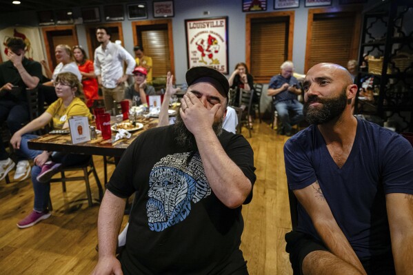 Sean Cannon, a Louisville resident, reacts during a watch party of the presidential debate between President Joe Biden and Republican presidential candidate former President Donald Trump at Old Louisville Tavern on Thursday, June 27, 2024, in Louisville, Ky. (AP Photo/Jon Cherry)