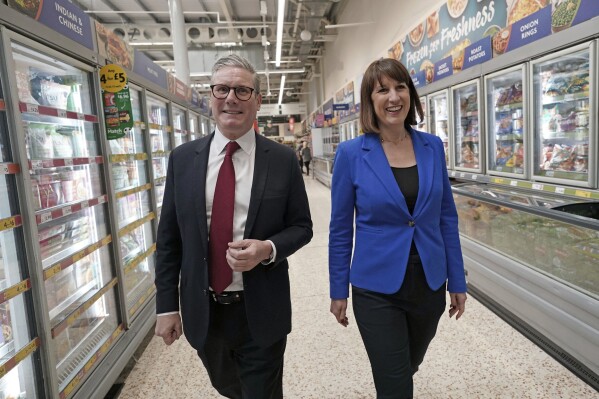 Labour Party leader Keir Starmer, left, and shadow chancellor Rachel Reeves to a supermarket while on the general election campaign trail, in Wiltshire, England, Wednesday, June 19, 2024. (Stefan Rousseau/PA via AP)