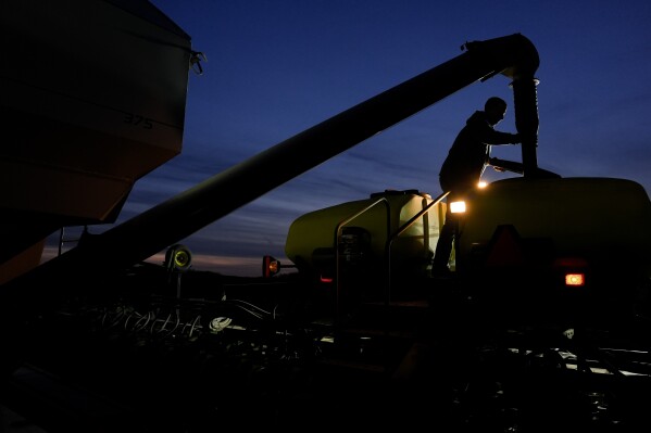 FILE - Mark Woodruff loads soybean seeds into a planter on April 22, 2024, in Sabina, Ohio. On Thursday, June 13, 2024, The labor department releases producer prices data for May. (AP Photo/Joshua A. Bickel, File)