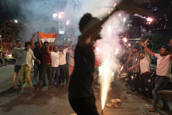 Cricket fans light fireworks to celebrate in Lucknow, capital of northern Indian state of Uttar Pradesh, India, Sunday, June 30, 2024, after India defeated South Africa in the ICC T20 World Cup final match in Barbados. (AP Photo/Rajesh Kumar Singh)