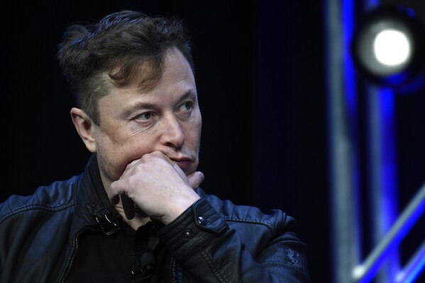 FILE - Tesla and SpaceX chief executive officer Elon Musk listens to a question as he speaks at the SATELLITE Conference and Exhibition in Washington, March 9, 2020. A Delaware judge heard arguments Monday, July 8, 2024, over a massive and unprecedented fee request by lawyers who argued that a massive and unprecedented pay package for Tesla CEO Musk was illegal and should be voided. (AP Photo/Susan Walsh, File)