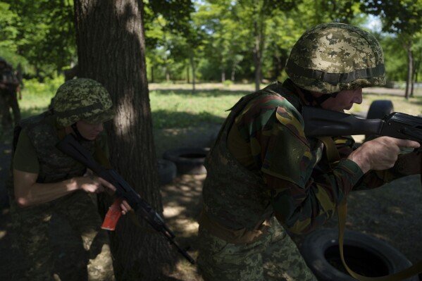 Convict prisoners who have joined the Ukrainian army train at the polygon, in the Dnipropetrovsk region, Ukraine, Saturday, June 22, 2024. Ukraine is expanding its military recruiting to cope with battlefield shortages more than two years into fighting Russia’s full-scale invasion. (AP Photo/Evgeniy Maloletka)