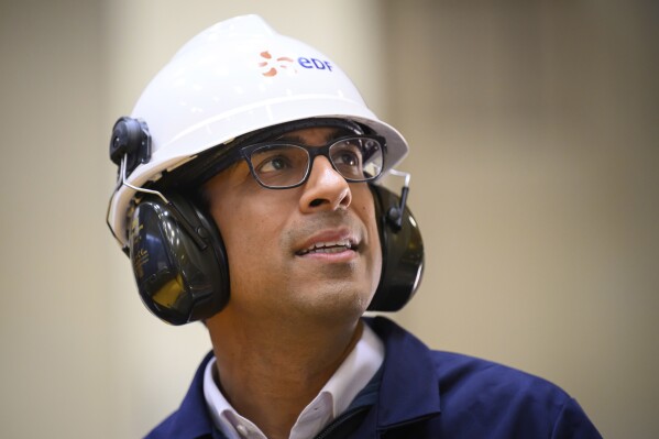 Britain's Prime Minister Rishi Sunak is given a tour of the Sizewell B nuclear power facility by Station Director Robert Gunn in Sizewell, England, Wednesday, June 19, 2024. (Leon Neal/Pool Photo via AP)
