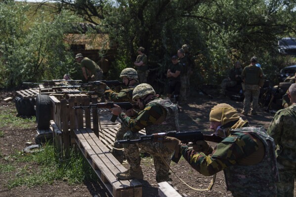 Convict prisoners who have joined the Ukrainian army train at the polygon, in the Dnipropetrovsk region, Ukraine, Saturday, June 22, 2024. Ukraine is expanding its military recruiting to cope with battlefield shortages more than two years into fighting Russia’s full-scale invasion. (AP Photo/Evgeniy Maloletka)