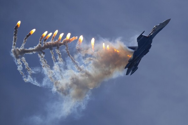 A Sukhoi Su-35S jet fighter of the Russian Knights aerobatic team performs during the International Maritime Defence Show 'Fleet-2024' in Kronstadt, outside St. Petersburg, Russia, Friday, June 21, 2024. (AP Photo/Dmitri Lovetsky)