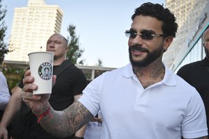 Russian singer and entrepreneur Timur Yunusov, better known as Timati, poses in front of a newly opened Stars Coffee coffee shop in the former location of the Starbucks coffee shop in Moscow, Russia, Thursday, Aug. 18, 2022