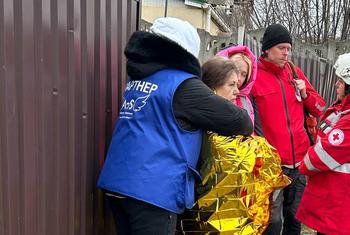 Civil society groups work at the site of a recent attack in Dnipro. 