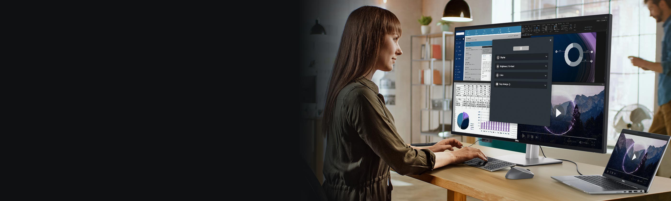 Woman using Dell products at a table in front of her.