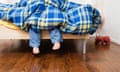 A child under a duvet in pyjamas