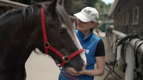 Carriage horse Sam and stables manager Natalie