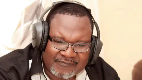 Malawian musician Lucius Banda wearing headphones