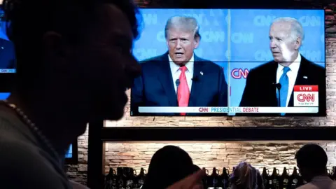 Guests at the Old Town Pour House watch a debate between President Joe Biden and presumptive Republican nominee former President Donald Trump on June 27, 2024 in Chicago, Illinois