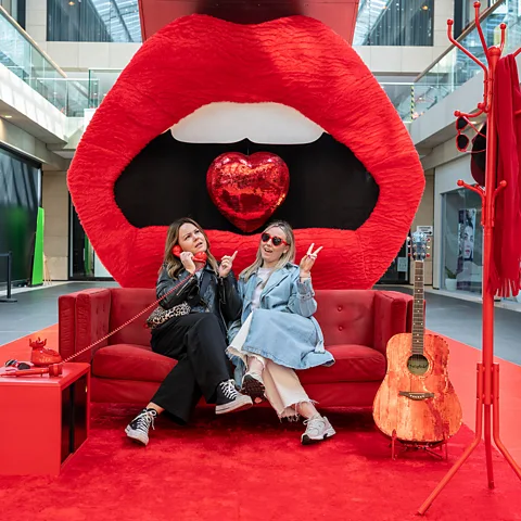 Visit Liverpool Giant red lips form the backdrop for this artwork inspired by Taylor Swift's Red era (Credit: Visit Liverpool)