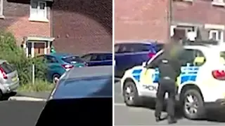 The footage shows a man in a green hoodie