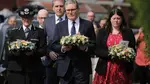 Prime Minister Keir Starmer is seen carrying a floral tribute (centre) near the scene in Hart Street, Southport