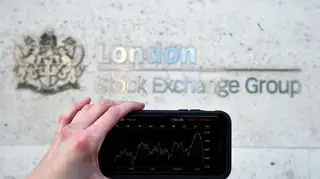 A person views stocks and shares on their phone