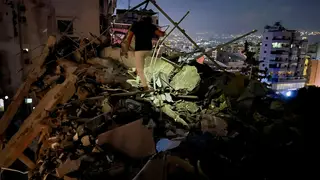 A man inspects a destroyed building that was hit by an Israeli airstrike in the southern suburbs of Beirut, Lebanon, Tuesday, July 30, 2024.