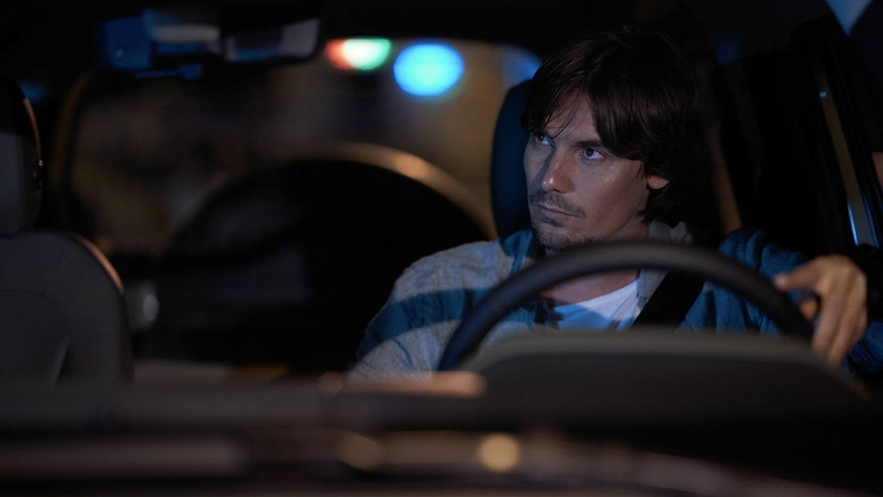 A driver looks through the windscreen of a Defender