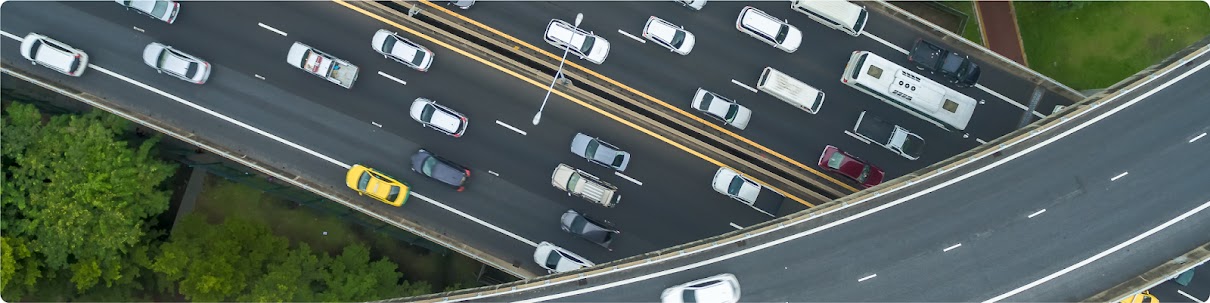 Overhead shot of cars about on a freeway going under and underpass