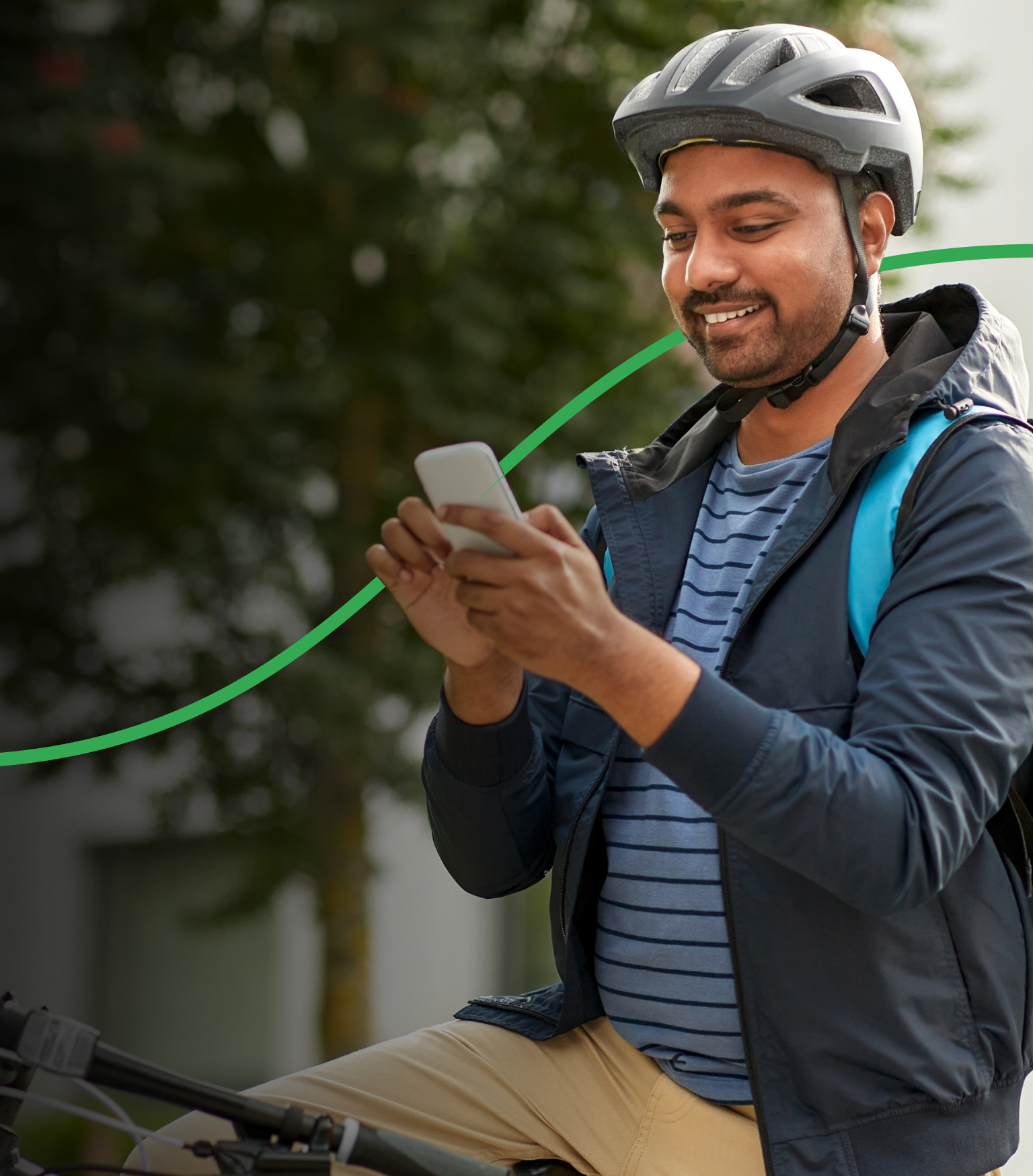 Bicycle delivery person checking his phone