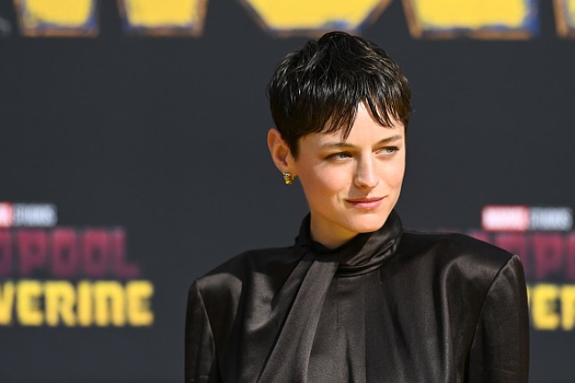 Emma Corrin in a black outfit with dark hair at the premiere of Deadpool & Wolverine