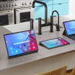 New Lenovo tablets and smart devices lined up on a kitchen counter