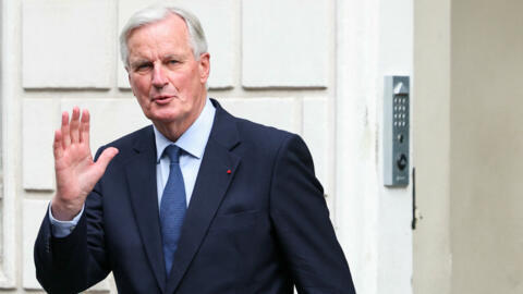 Newly appointed Prime Minister Michel Barnier gestures as he arrives for  the handover ceremony in Paris on September 5, 2024.