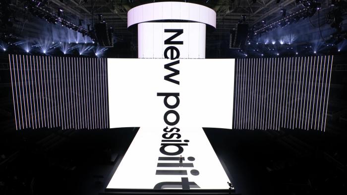 Still from the stream of Samsung’s January 2024 Unpacked event in California. The stage and screen above it show a marquee with the words "New possibilities."