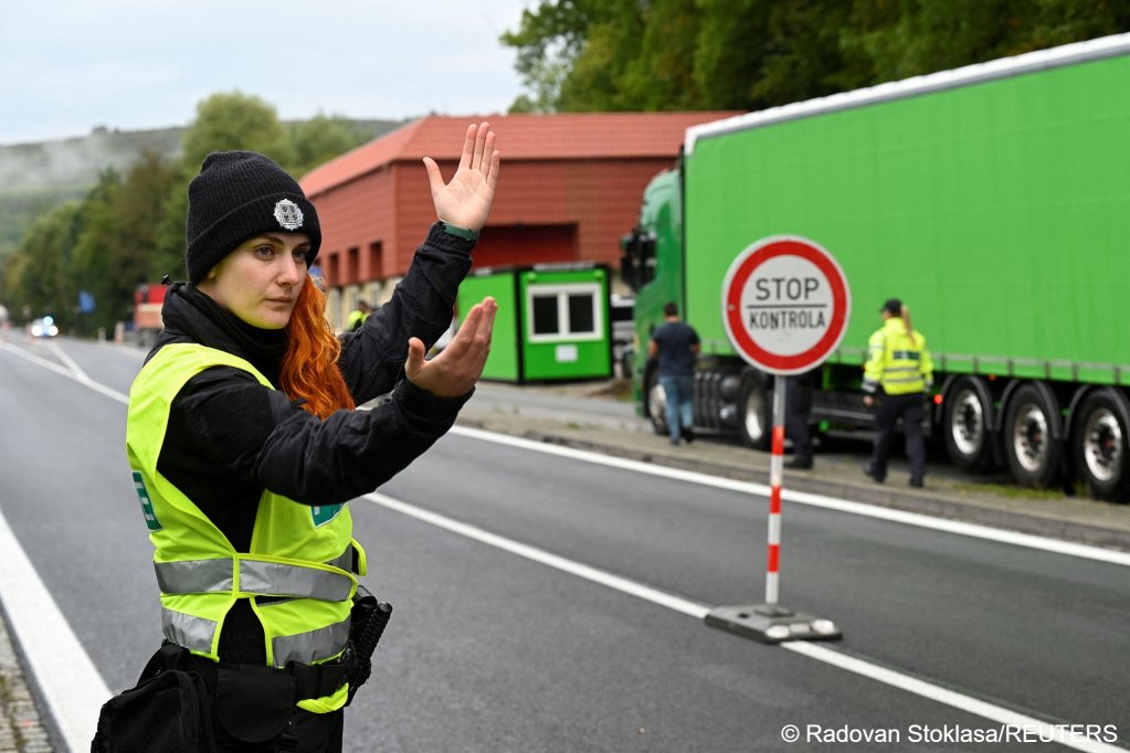 From file: A police officer directs the traffic, as they check vehicles at the Czech-Slovak border | Photo: Radovan Stoklasa / Reuters